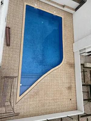 a large swimming pool on the side of a building at Algarve, modern T1 apartment with balcony, Quarteira in Quarteira