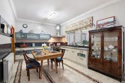 a large kitchen with a wooden table and chairs at Casa da Cidade de Loulé in Loulé