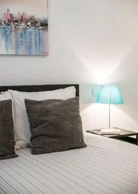 a bedroom with a bed with a blue lamp on a table at Albufeira Old Town Center - VERASOL 2 in Albufeira
