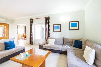 a living room with two couches and a coffee table at Villa Hawaii by Algarve Vacation in Albufeira