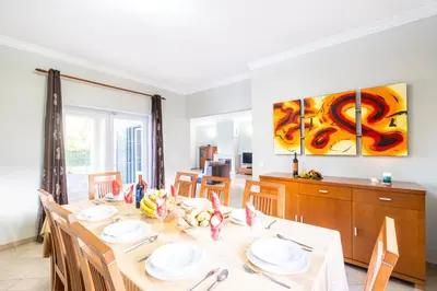 a dining room with a table and chairs at Villa Hawaii by Algarve Vacation in Albufeira