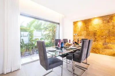 a dining room with a glass table and chairs at Villa Laura by Algarve Vacation in Albufeira