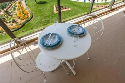 a white table with blue plates and glasses in a window at Apartment Aria - Great area for children in Albufeira