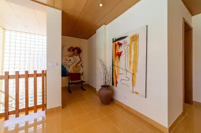 a hallway with a large painting on the wall at Villa Marina in Albufeira