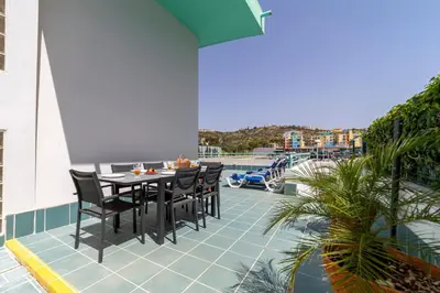 a patio with a table and chairs on a balcony at Villa Marina in Albufeira