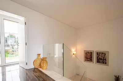 a white room with vases sitting on a table at BeGuest Albufeira Luxus Villa in Albufeira