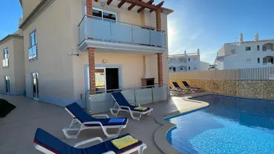 a patio with chairs and a swimming pool at Oura Oasis A by Check-in Portugal in Albufeira