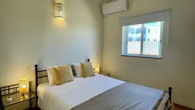 a bedroom with a bed with white sheets and a window at Oura Oasis B by Check-in Portugal in Albufeira