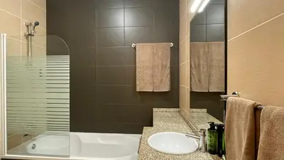 a bathroom with a sink and a shower and a tub at Oura Oasis B by Check-in Portugal in Albufeira