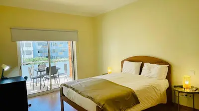 a bedroom with a bed and a balcony at Oura Oasis D by Check-in Portugal in Albufeira
