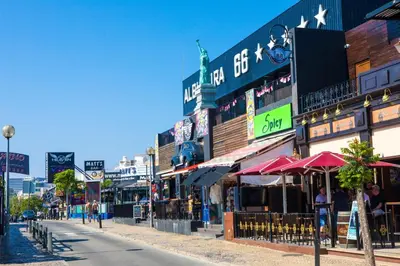 a city street with many shops and buildings at Oura Oasis D by Check-in Portugal in Albufeira
