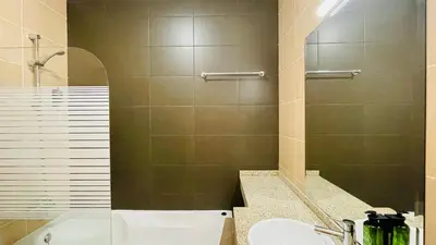 a bathroom with a shower and a sink and a tub at Oura Oasis E by Check-in Portugal in Albufeira
