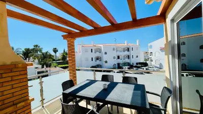 a patio with a table and chairs on a balcony at Oura Oasis E by Check-in Portugal in Albufeira
