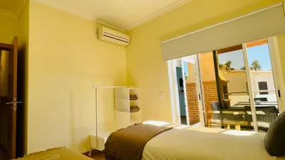 a bedroom with a bed and a large window at Oura Oasis E by Check-in Portugal in Albufeira