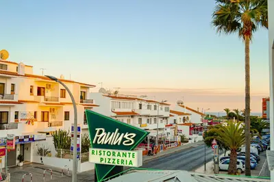 a sign for a rinisitage pizzeria on a city street at Oura Oasis F by Check-in Portugal in Albufeira