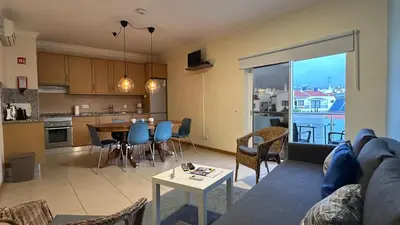a living room and kitchen with a couch and a table at Oura Oasis F by Check-in Portugal in Albufeira