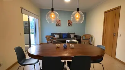a living room with a wooden table and chairs at Oura Oasis F by Check-in Portugal in Albufeira