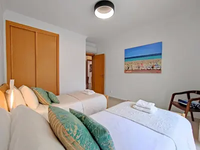 a hotel room with two beds and a couch at Sao Rafael Beach Luxury Home by Be Cherish in Albufeira