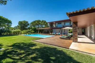 a house with a large yard with a swimming pool at Villa Atlantic Pearl - Luxury villa located in in Quinta do Lago