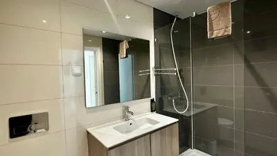 a bathroom with a sink and a shower and a mirror at Moon by Check-in Portugal in Albufeira