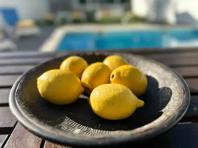 a bowl of lemons on top of a wooden table at Moon by Check-in Portugal in Albufeira
