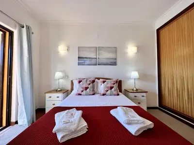 a bedroom with a bed with two towels on it at Vilamoura Paradise Golf With Pool by Homing in Vilamoura