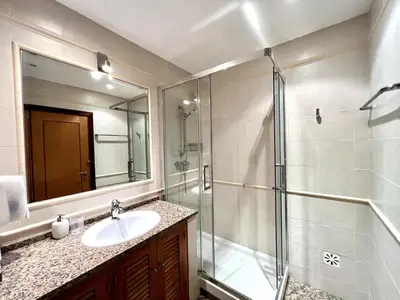 a bathroom with a sink and a glass shower at Vilamoura Paradise Golf With Pool by Homing in Vilamoura