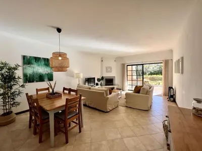 a large living room with a table and chairs at Vilamoura Paradise Golf With Pool by Homing in Vilamoura