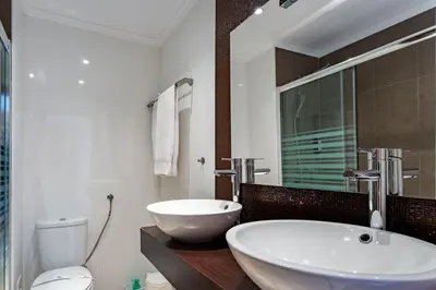 a bathroom with a large white sink and a toilet at Duas Palmeiras by LovelyStay in Albufeira