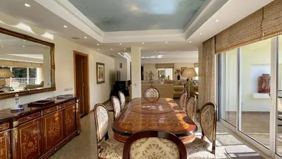 a dining room with a wooden table and chairs at Azaleas by Check-in Portugal in Vilamoura