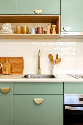 a kitchen counter with a sink and wooden utensils at Estúdio do Largo - Vilamoura in Vilamoura