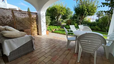 a patio with a table and chairs on a patio at Sao Rafel Beach house in Albufeira