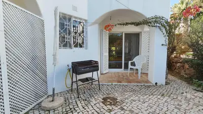 a white house with a piano on a patio at Sao Rafel Beach house in Albufeira