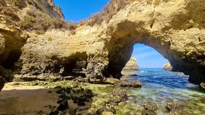 an arch in the rocks on the beach at Sao Rafel Beach house in Albufeira