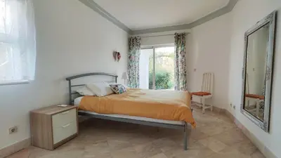 a bedroom with a bed and a window at Sao Rafel Beach house in Albufeira