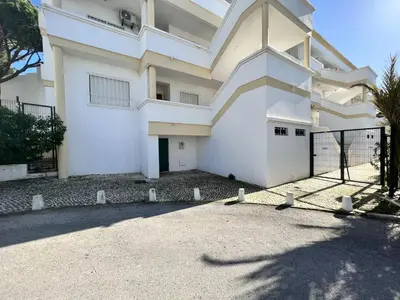 a white building with a gate in front of it at Vilamoura Garden View 1 With Pool by Homing in Vilamoura