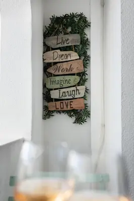 a sign that reads live dream work imagine laugh love hanging on a wall at Timi's House - Espaçoso apartamento a 350 m da praia e centro da cidade velha in Albufeira