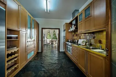 a large kitchen with wooden cabinets and a sink at Villa Mauri Luxe - Beautiful beachfront villa in Albufeira