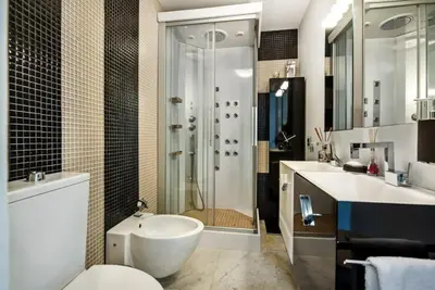 a bathroom with a shower and a toilet and a sink at Villa Plage Grande - Superstar luxury - Beachtop in Olhos de Água