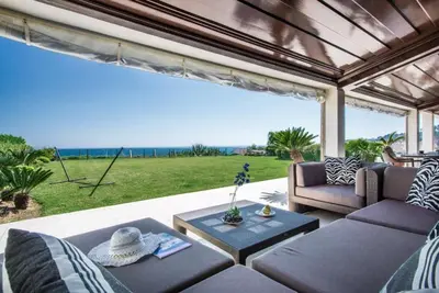 a living room with a view of the ocean at Villa Plage Grande - Superstar luxury - Beachtop in Olhos de Água