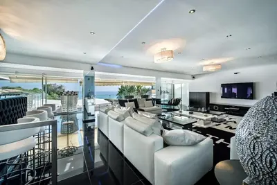 a living room with white furniture and a view of the ocean at Villa Plage Grande - Superstar luxury - Beachtop in Olhos de Água
