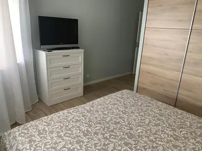 a bedroom with a bed and a television on a dresser at Eine Wohnung für den perfekten Urlaub !!! in Quarteira