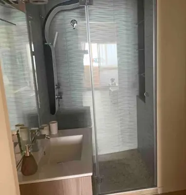 a bathroom with a sink and a glass shower at Eine Wohnung für den perfekten Urlaub !!! in Quarteira