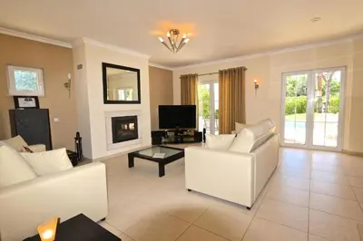 a living room with white furniture and a fireplace at Spacious Vilamoura Villa 4 Bedrooms Villa Amendoeira Table Tennis in Quarteira