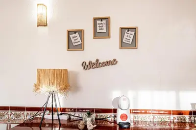 a room with a white wall with pictures on it at BeGuest Santa Eulália Apartment in Albufeira