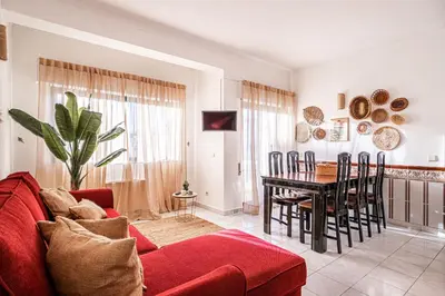 a living room with a red couch and a table at BeGuest Santa Eulália Apartment in Albufeira