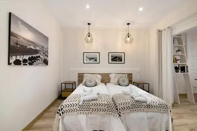 a bedroom with a bed and a vanity and a mirror at Casa na Travessa in Faro