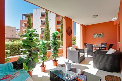 a balcony with chairs and a table and plants at Victoria Garden in Vilamoura