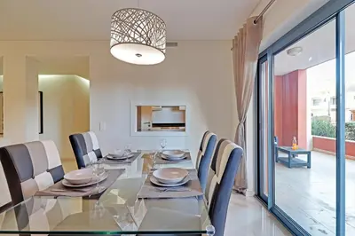 a dining room with a glass table and chairs at Victoria Secret in Vilamoura
