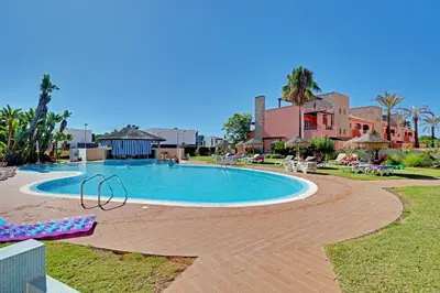 a swimming pool with chaise lounges in a resort at Victoria Secret in Vilamoura